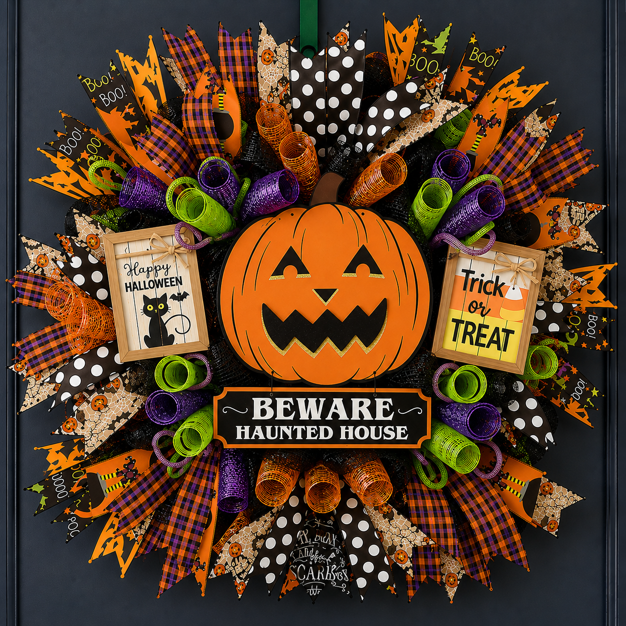 Premium Halloween deco mesh wreath with pumpkin centerpiece, Halloween ribbon, and layered mesh curls in orange, black, purple and green.