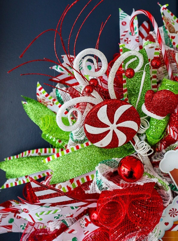 Detailed view of premium wired Christmas ribbon, deco mesh, peppermint ornaments, and handcrafted accents on a luxury Christmas wreath.