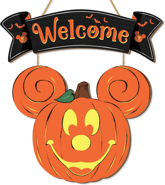 Handmade wooden Halloween pumpkin welcome door hanger displayed on a front door with vibrant orange and black colors.