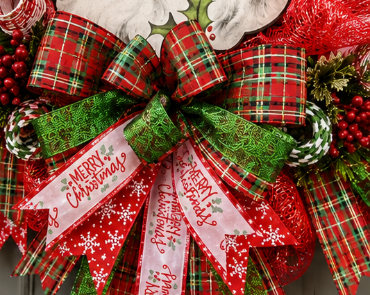 Close-up of the layered plaid bow and Christmas print ribbon on a handmade Vintage Santa Christmas wreath.