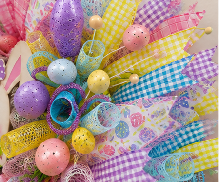 Detailed close-up of premium wired ribbon, deco mesh, Easter eggs, and decorative spring accents.