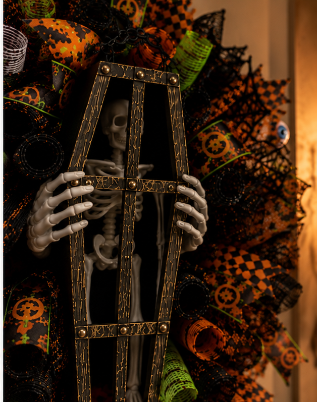 Close-up of premium Halloween ribbon, black deco mesh, orange mesh curls, lime green mesh rolls, and layered designer wreath construction.