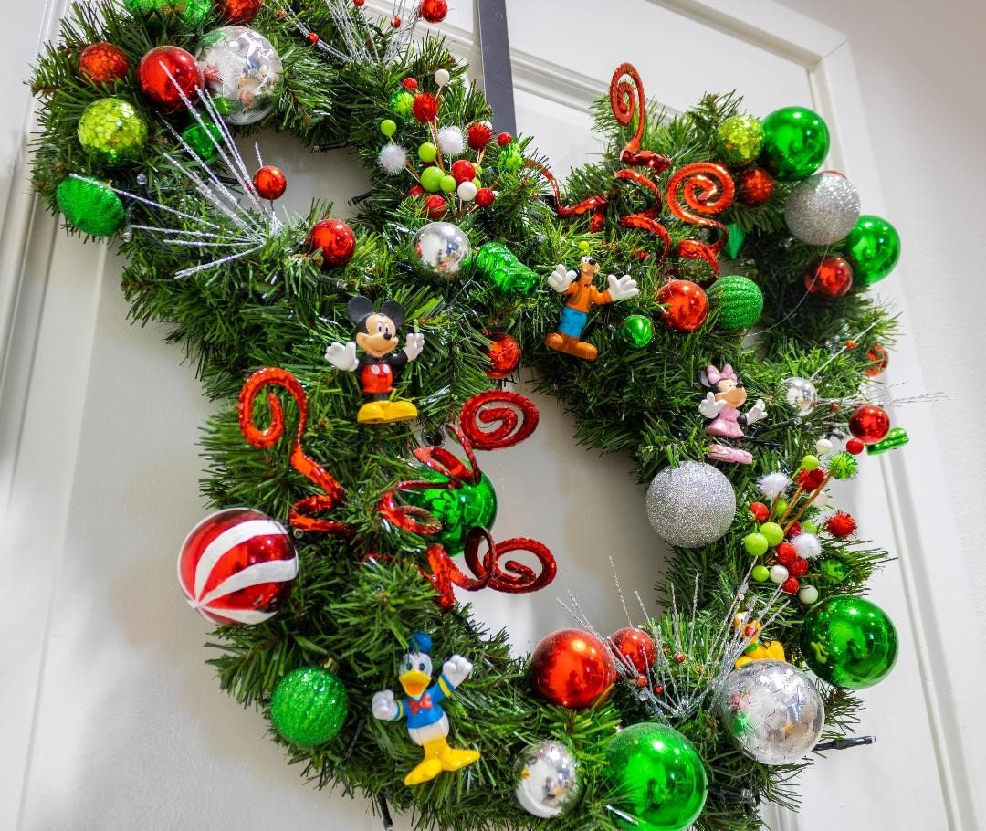 Disney Fans
Mouse-inspired Christmas wreath decorated with colorful ornaments and festive embellishments, perfect for holiday home decorating.